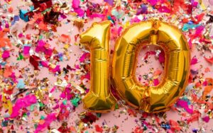 The number 10 formed by balloons, surrounded by confetti to illustrate a blog post about 10 years of Exceptional Futures.